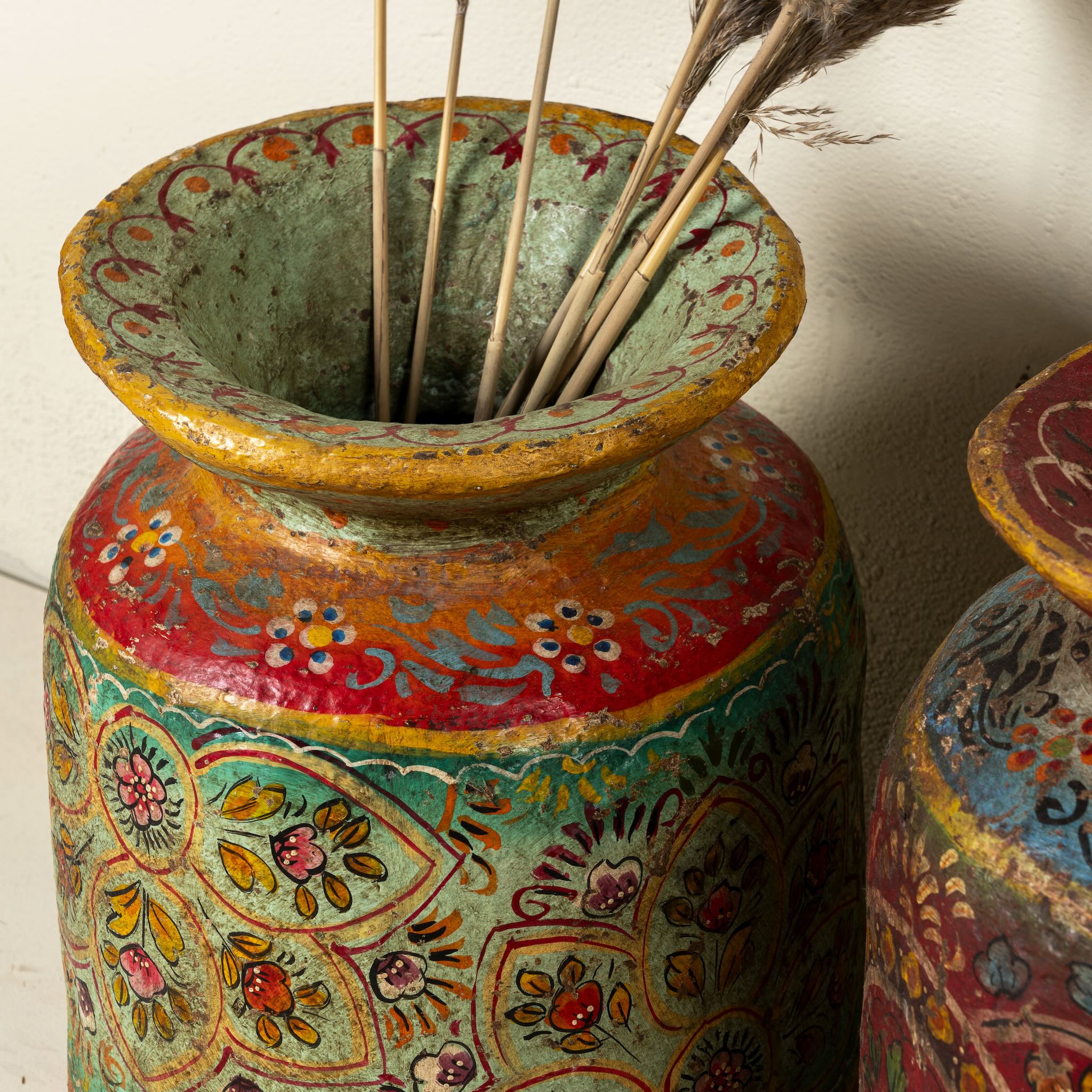 Close up image of a hand-painted papier-mâché vase Udanth in mixed colours with floral and folk motifs. A vintage home accessory and unique Indian decoration ideal for vintage home decor or use as a decorative statement vase.