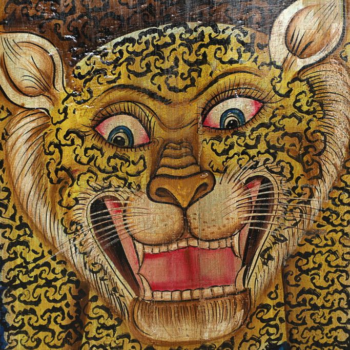 Close up image of a Vanij hand-painted tiger wall panel made from an old Indian teak door—an expressive old door panel reimagined as a vertical artwork with heritage and cultural depth.