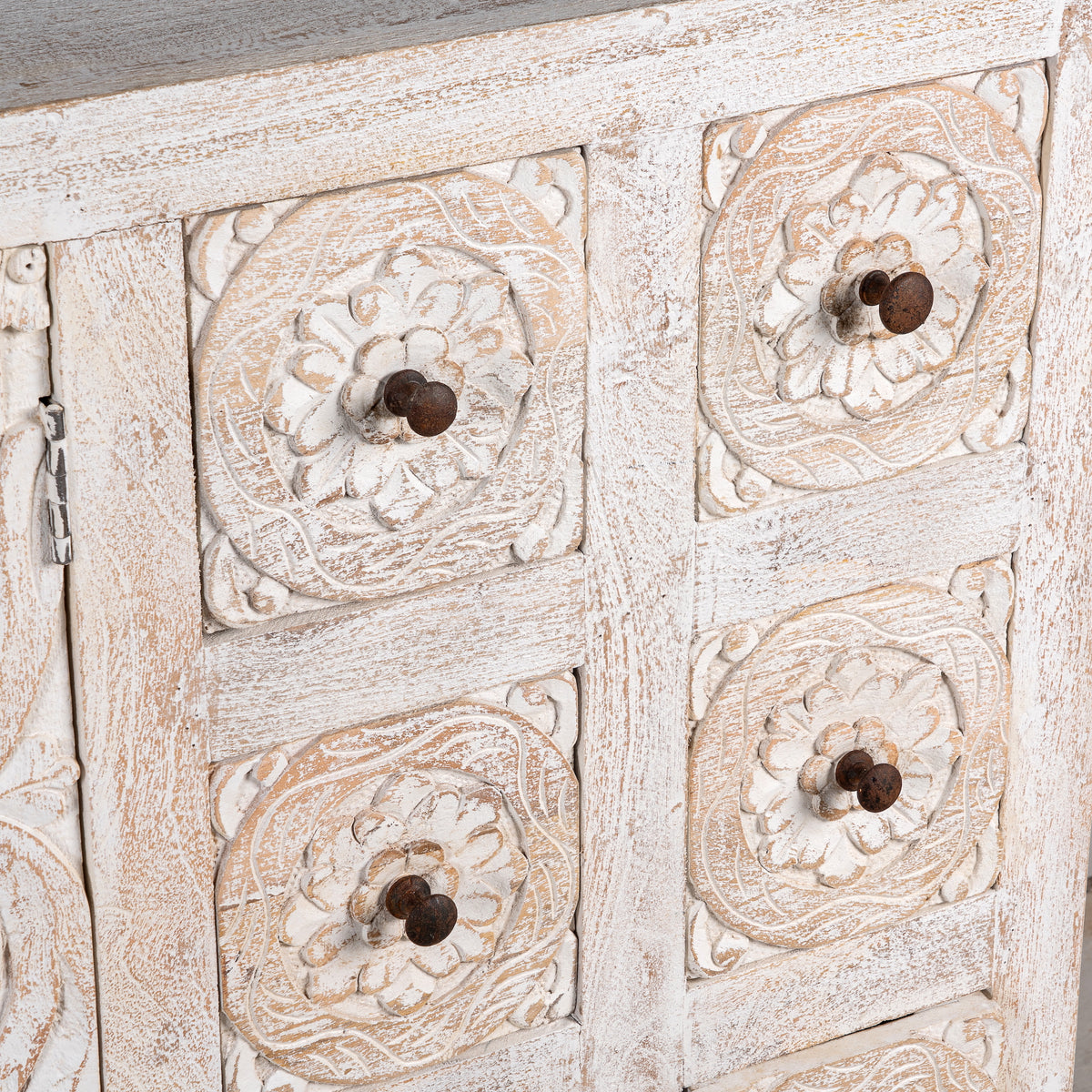 Close up image of a Varnika white-washed mango wood sideboard with hand-carved front, six small drawers and two doors, 180x50x85cm