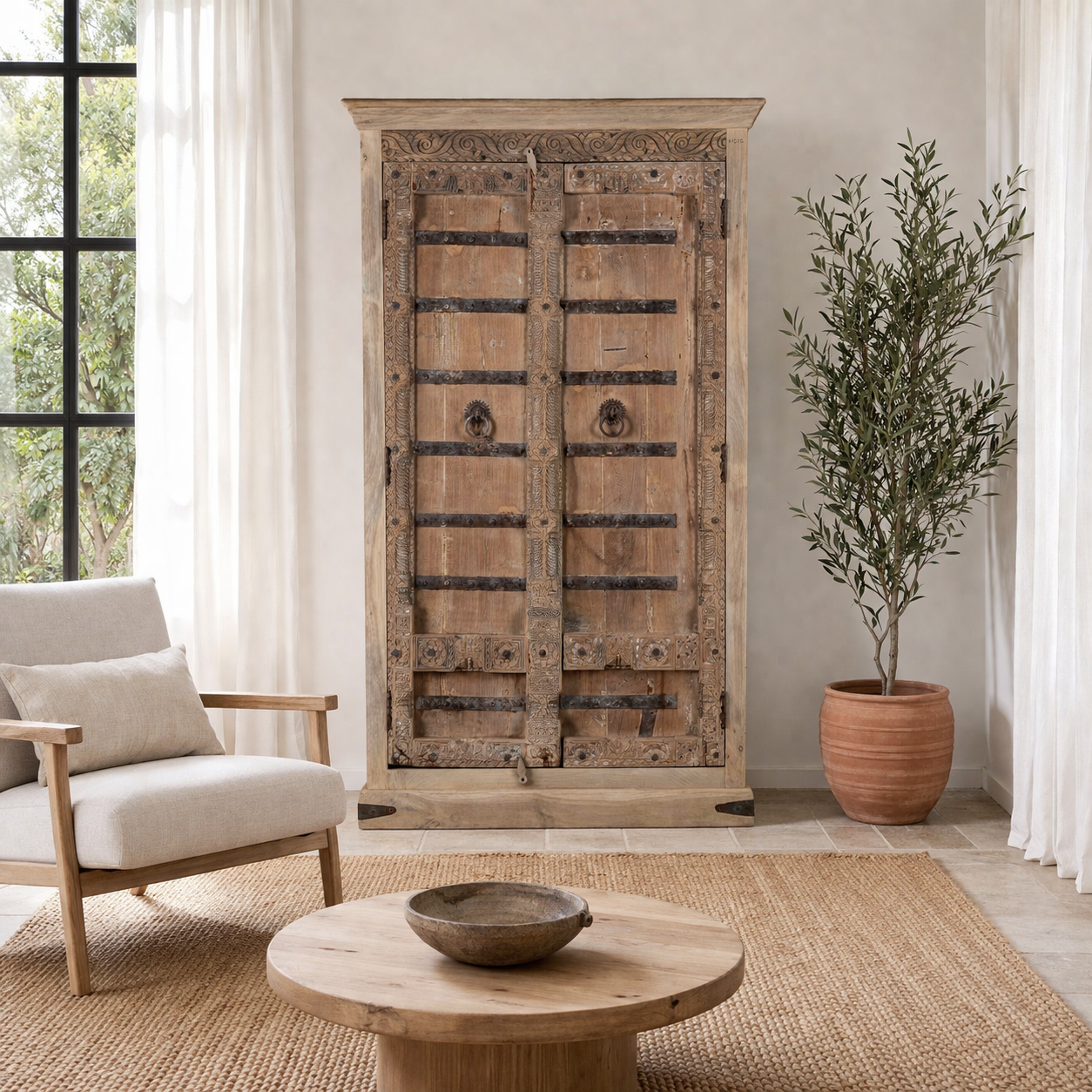 Lifestyle image with a Hand-carved teak wood wardrobe with original iron fittings – Veena model by Om Home & Garden