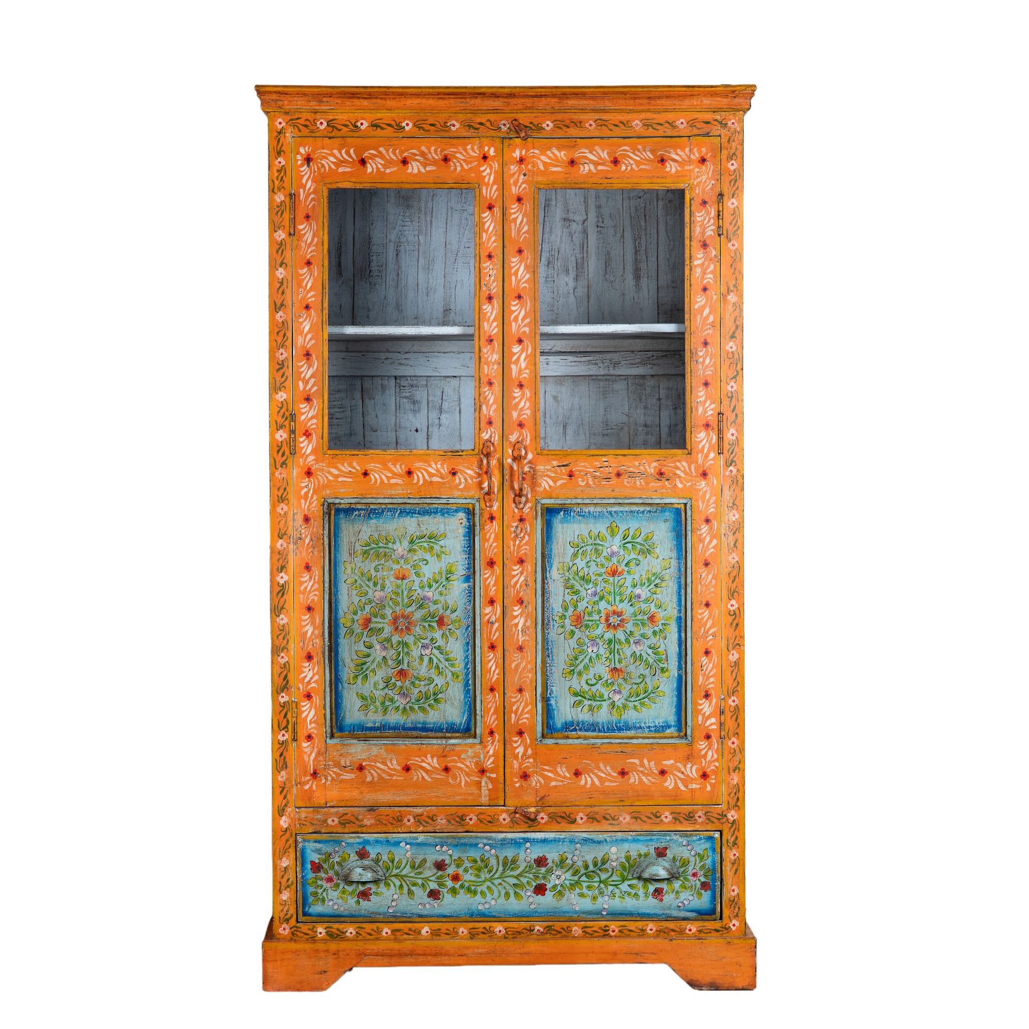 White background image of a hand-painted teak wood showcase with floral motifs and glass doors – sustainable furniture crafted from recycled wood with traditional Indian artistry.