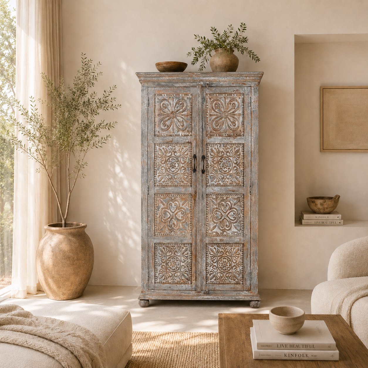 Lifestyle imagination of a hand-carved mango wood cabinet Ava in a vintage distressed finish with floral motifs. A stylish piece of mango wood furniture and vintage home accessory with practical storage and timeless charm.