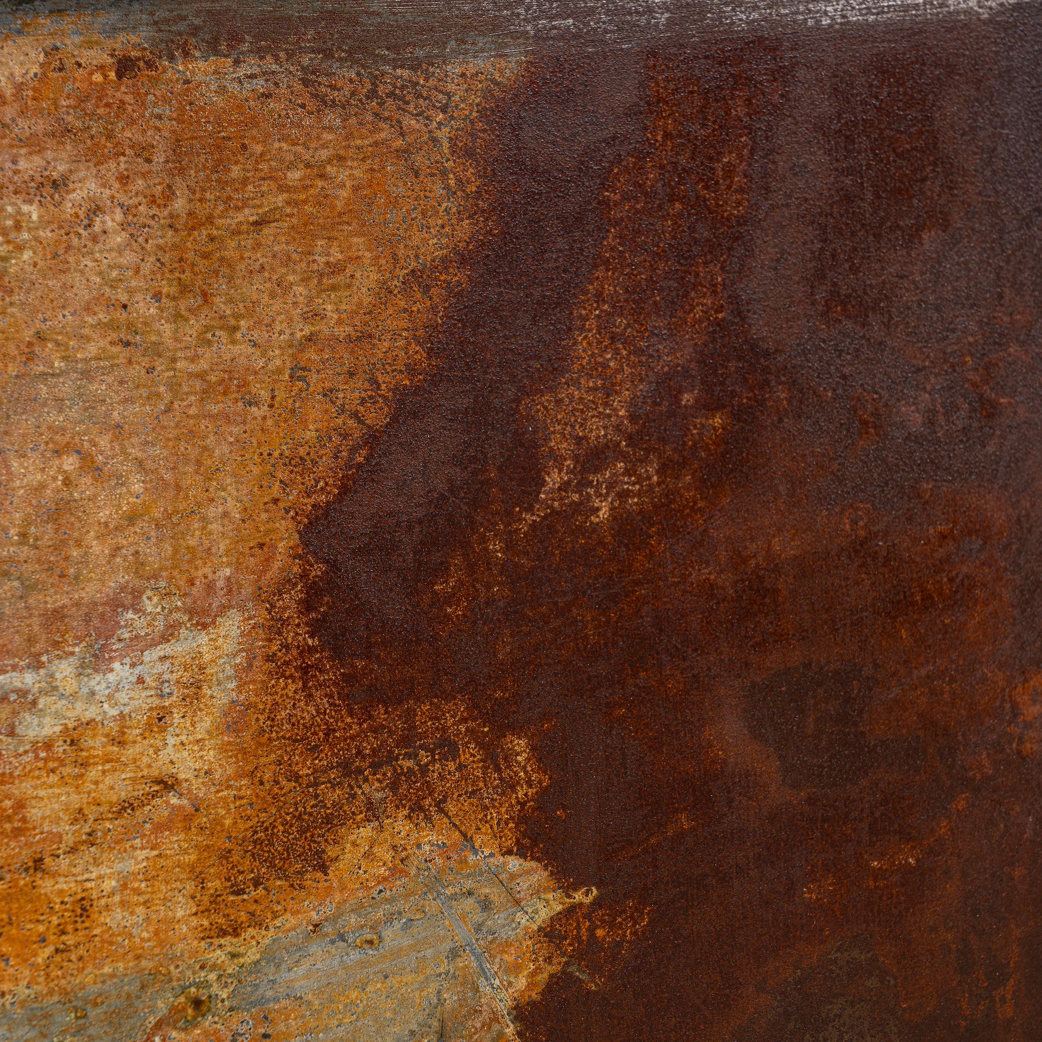 Close-up image of a rusted iron wall panel framed in teak wood with naturally formed abstract patterns – a unique iron wall decoration perfect for modern and industrial spaces.