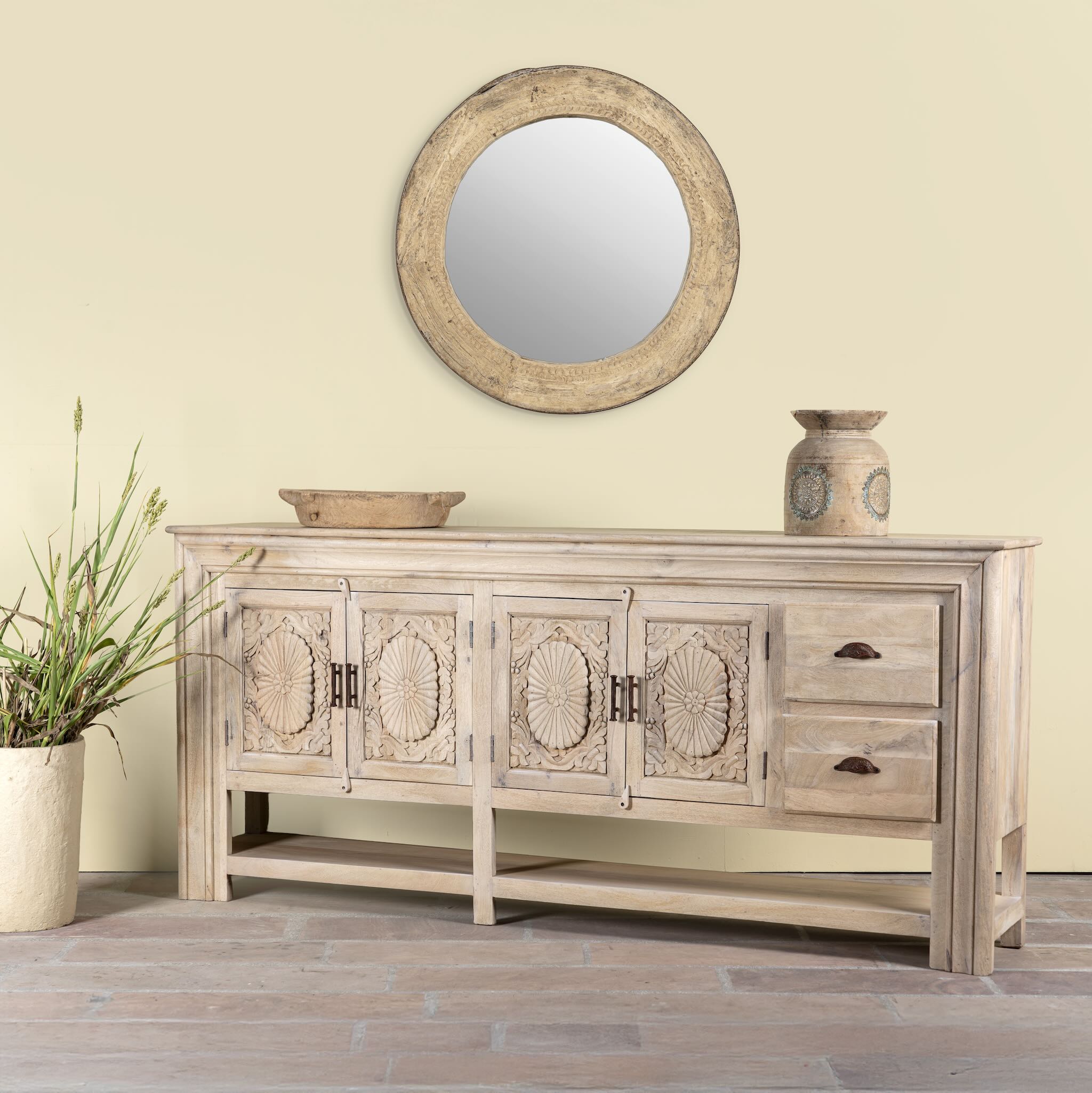 Side angle image of a hand-carved mango wood console table Zahira with 2 drawers and 4 doors in a natural finish. Elegant living room furniture piece with artistic detailing and practical storage.