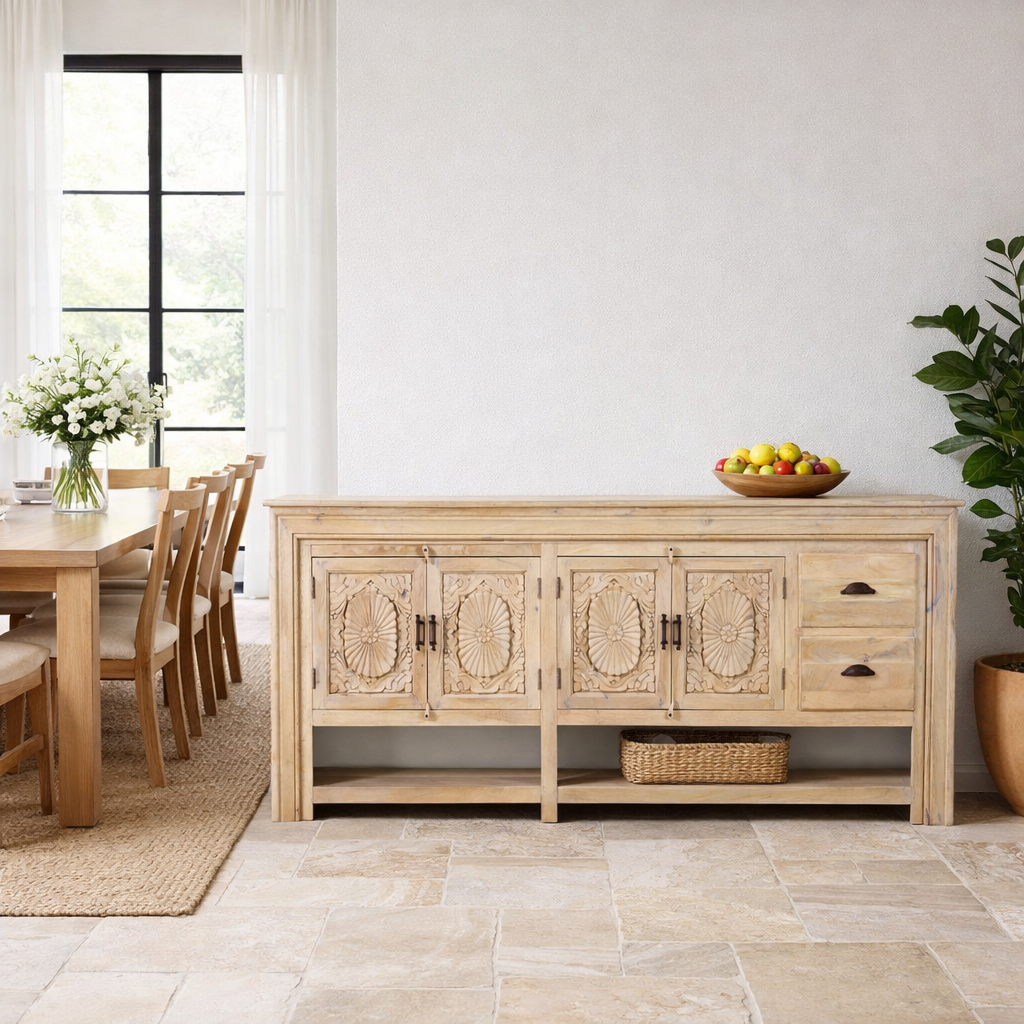 Lifestyle image of a of a hand-carved mango wood console table Zahira with 2 drawers and 4 doors in a natural finish. Elegant living room furniture piece with artistic detailing and practical storage.