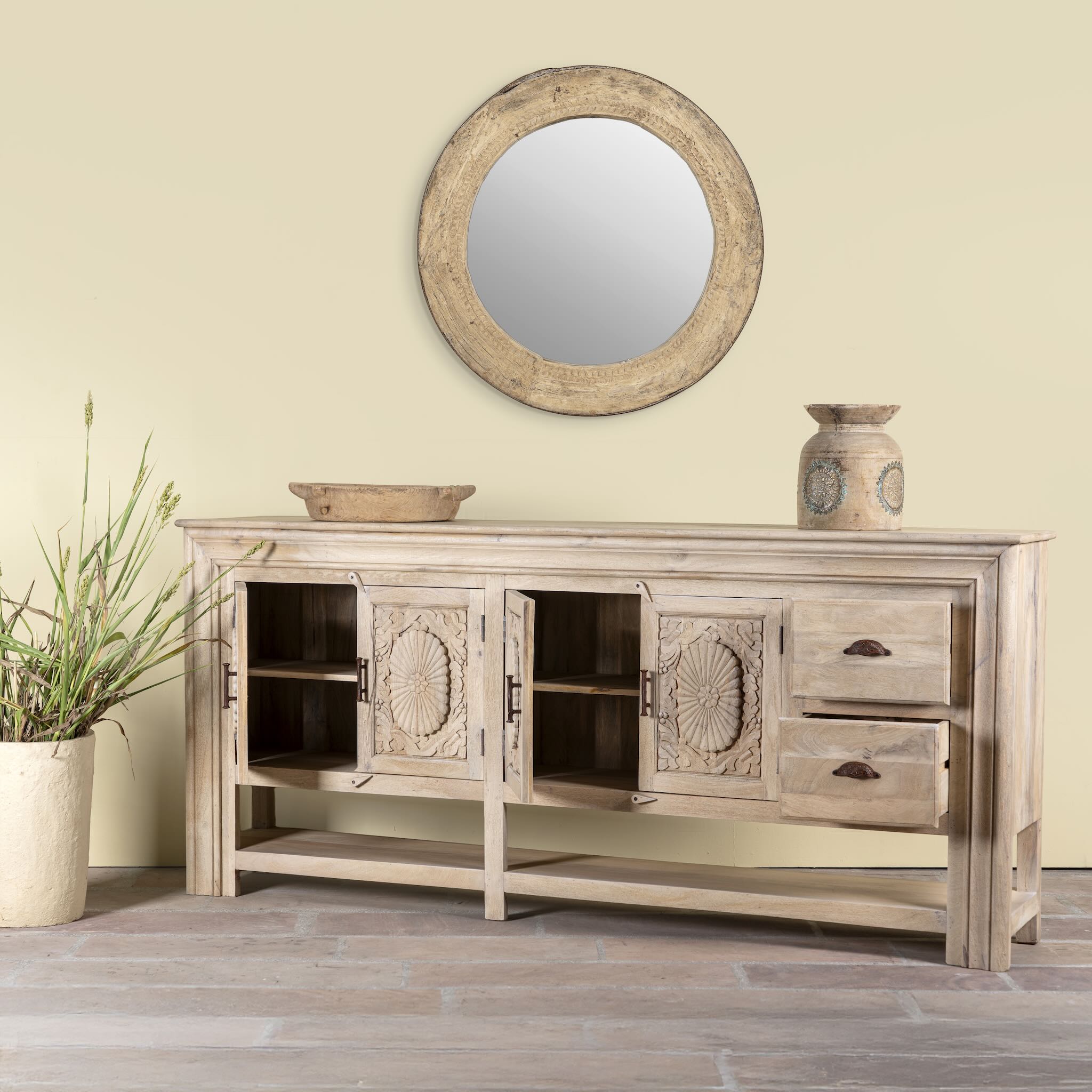 Side angle image with open drawers of a hand-carved mango wood console table Zahira with 2 drawers and 4 doors in a natural finish. Elegant living room furniture piece with artistic detailing and practical storage.