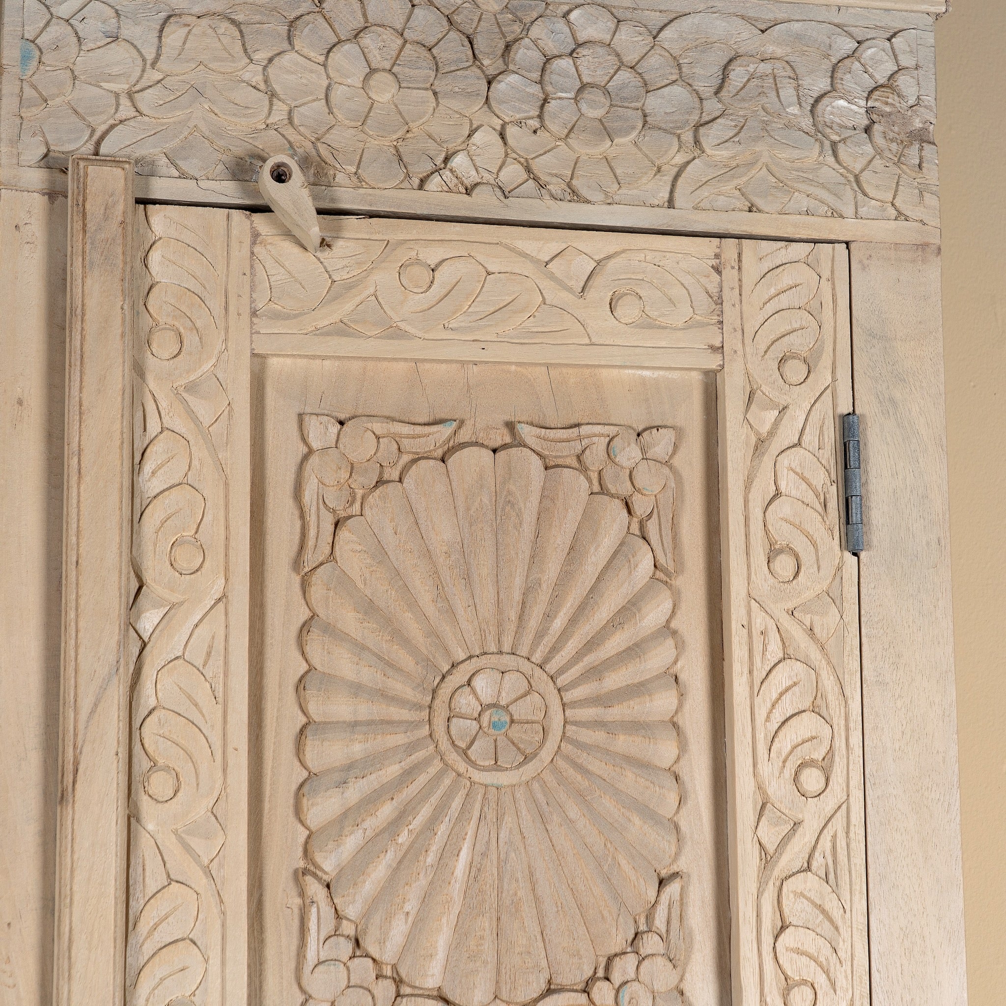Close up image of a Zaina hand carved bleached reclaimed wood cabinet with floral carved doors 221cm