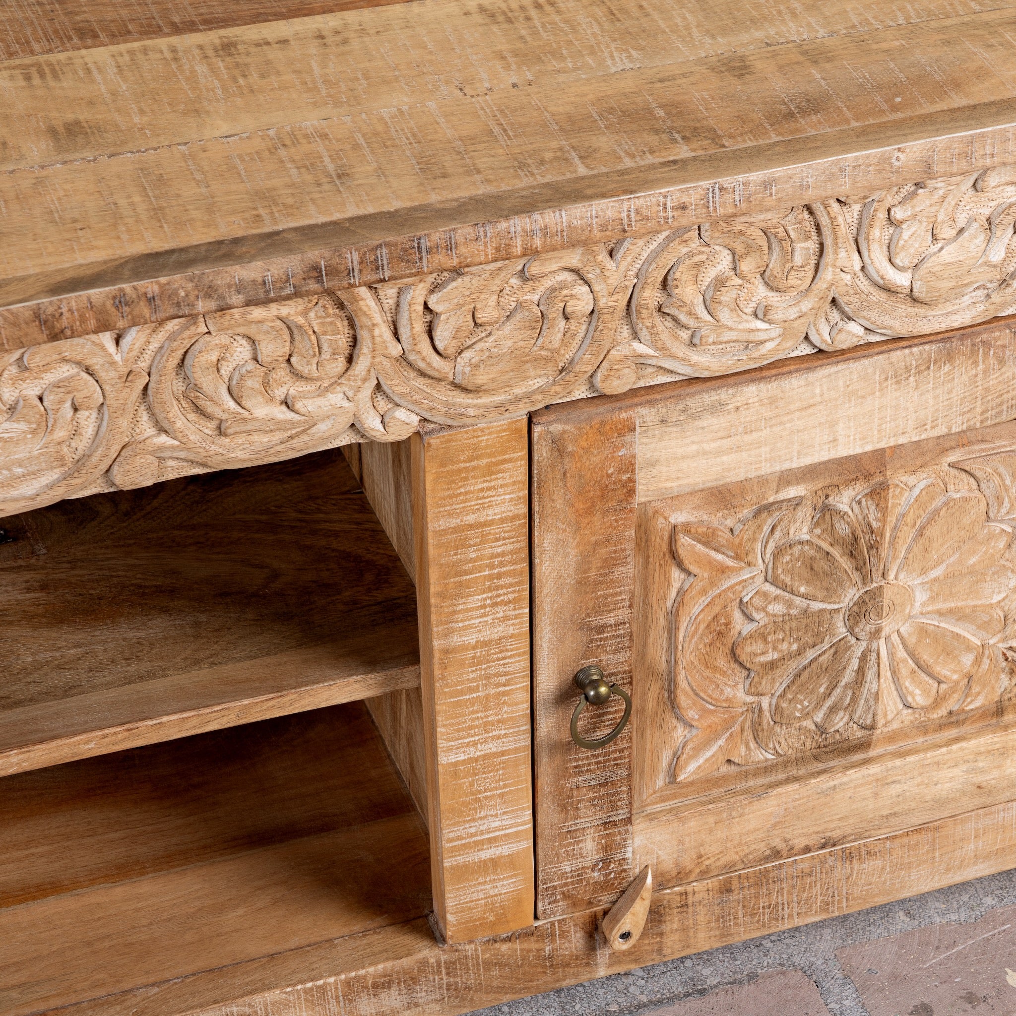 Close up image of a Zarina hand carved mango wood TV unit with floral carved doors 180cm