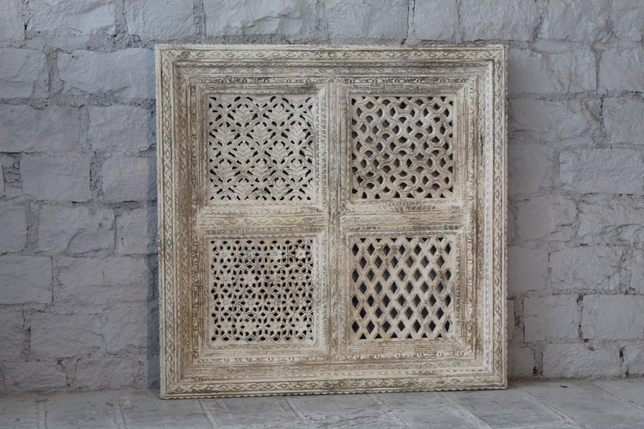 Square mango wood wall panel Akupara with intricate hand-carved detailing in soft, natural tones. A piece of unique wooden wall art perfect for wood wall decoration and carved wood furniture collections.