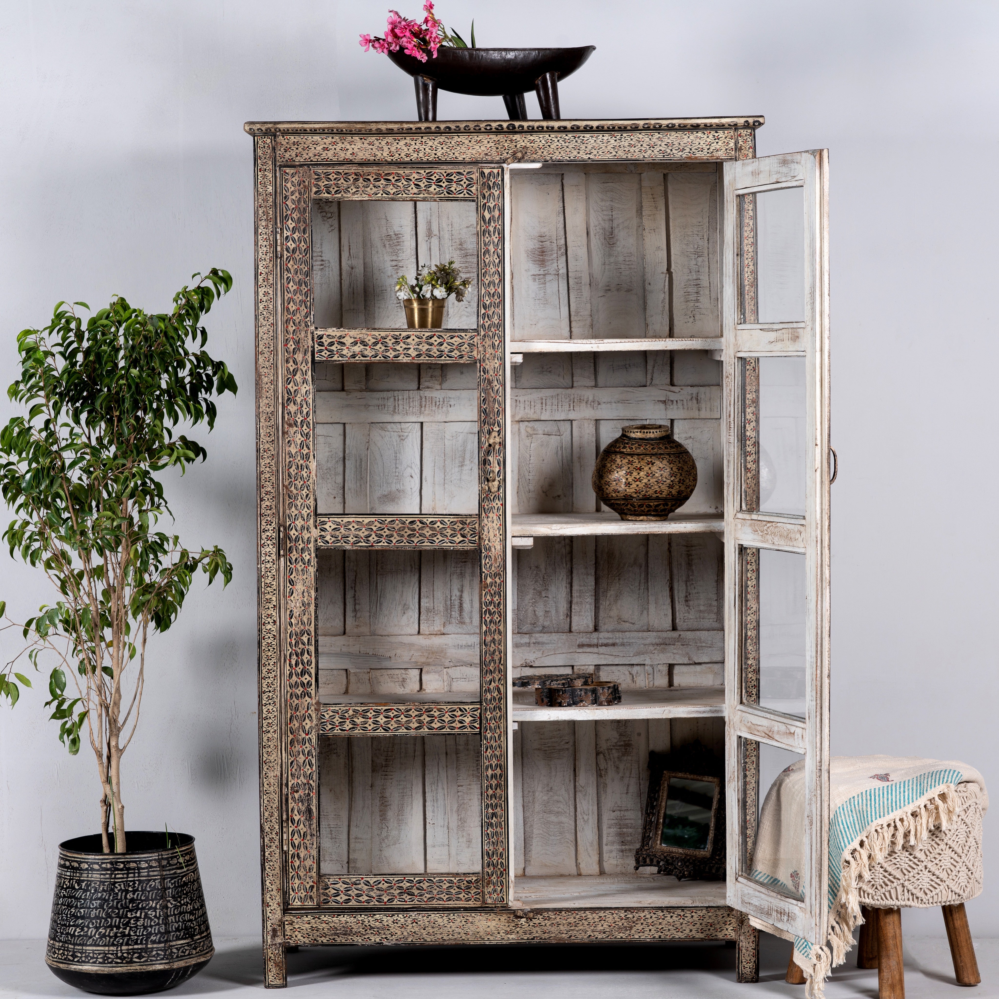 Open door image of a handcrafted reclaimed teak wood display cabinet with glass doors and hand-painted Sanskrit symbols – sustainable furniture with vintage soul and artisanal charm.