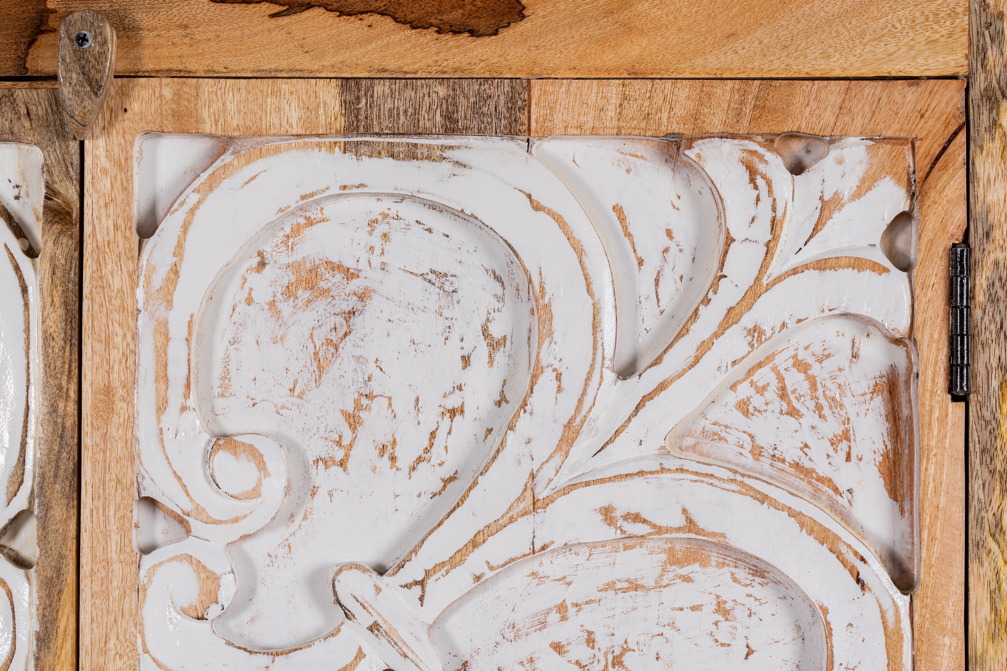 Close up image of a hand-carved mango wood wardrobe with floral motifs and whitewashed finish; wooden wardrobe ideal for bedroom furniture, 90 × 180 × 40 cm.