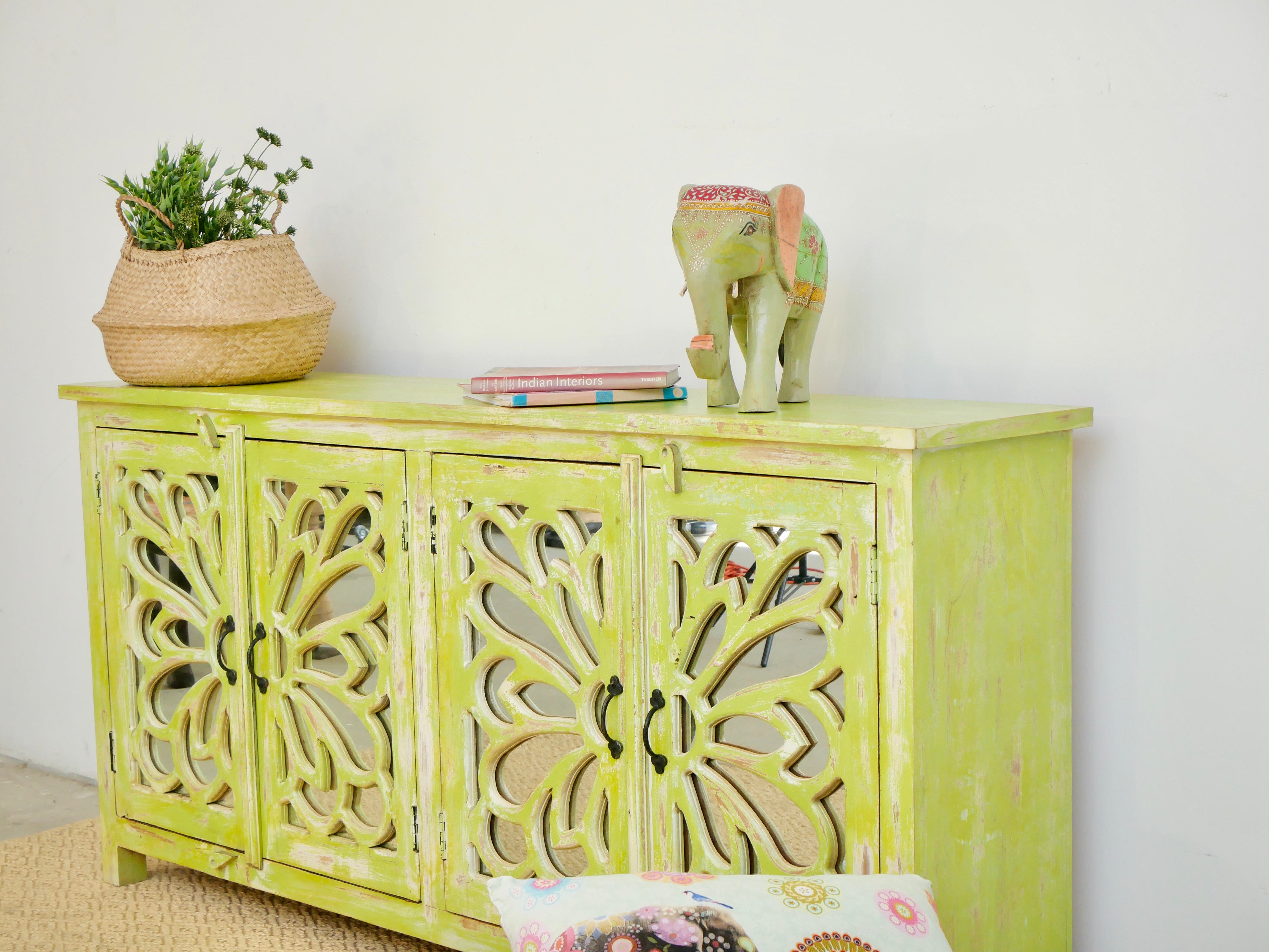 Side angle image of a Green Star hand carved mango wood sideboard with floral carvings and mirrored glass doors 180cm