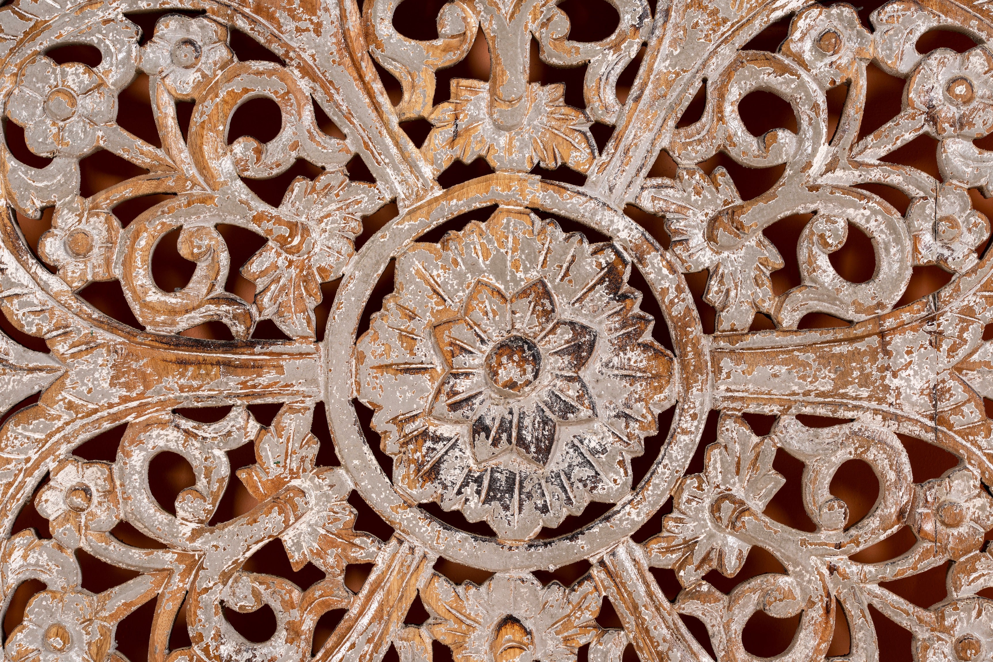 Close up image of a Lina carved wooden wall panel made from solid mango wood, featuring detailed hand-carved floral patterns—an elegant wooden wall decoration with artisanal charm.