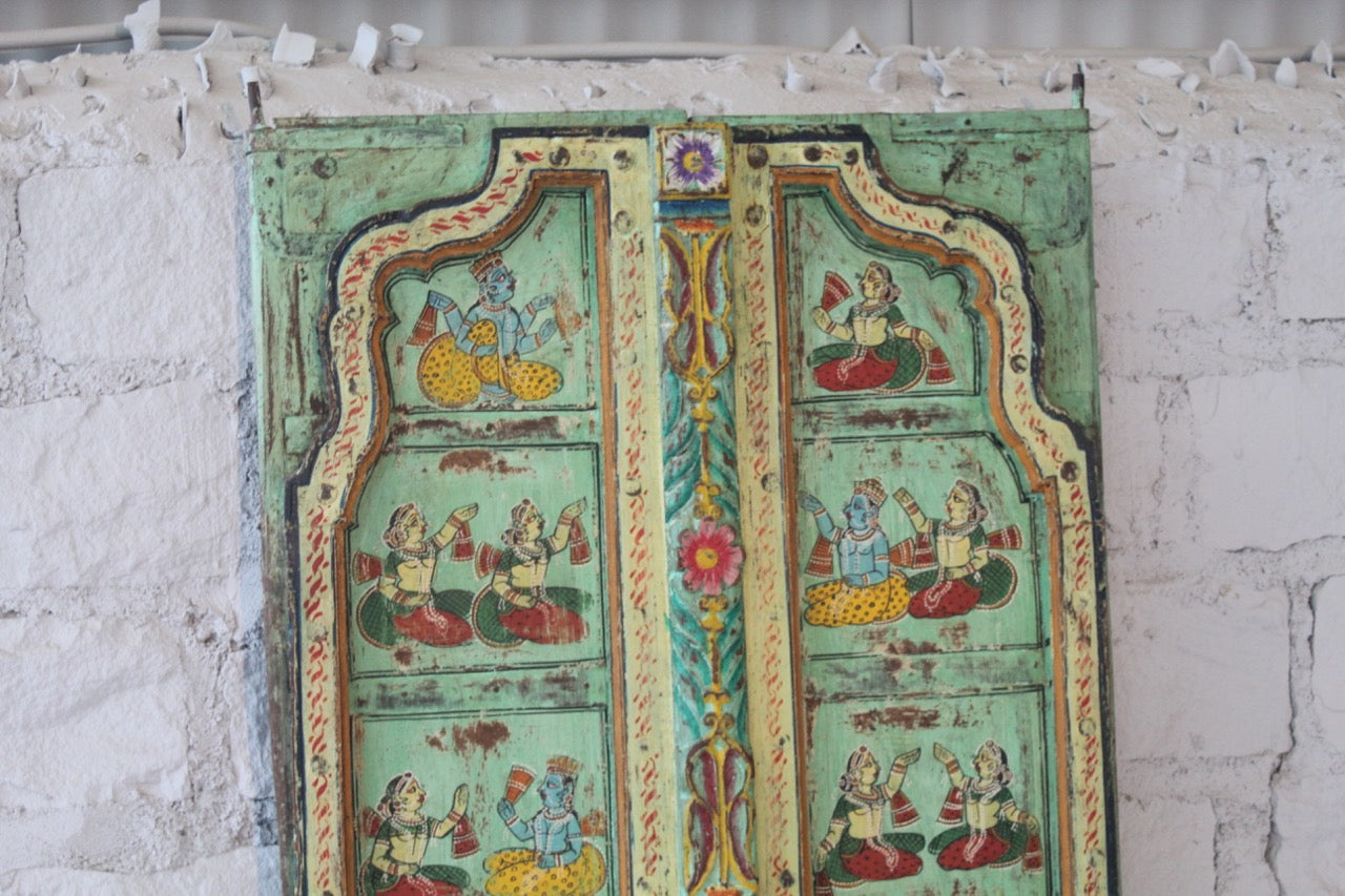 Close up image of a hand‑painted antique Indian old door panel Prabhaat with mythological scenes, crafted as unique Indian furniture and wall decoration. A vibrant teak wood piece perfect for vintage and artistic interiors.