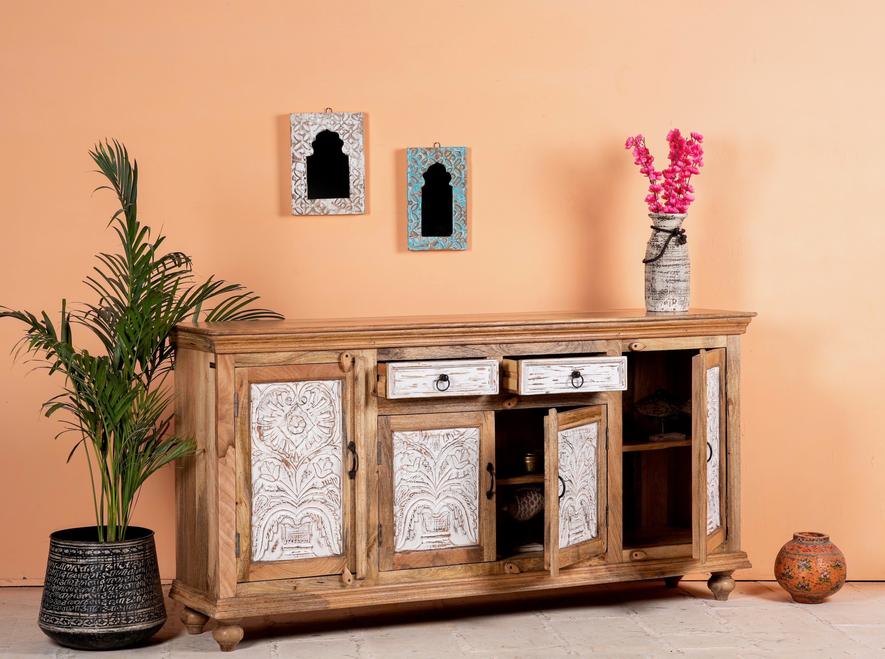 Side angle image with open doors of a Talaja handcrafted solid mango wood sideboard with intricately hand-carved doors, natural wood grain, traditional Indian patterns, and spacious storage, 180cm.