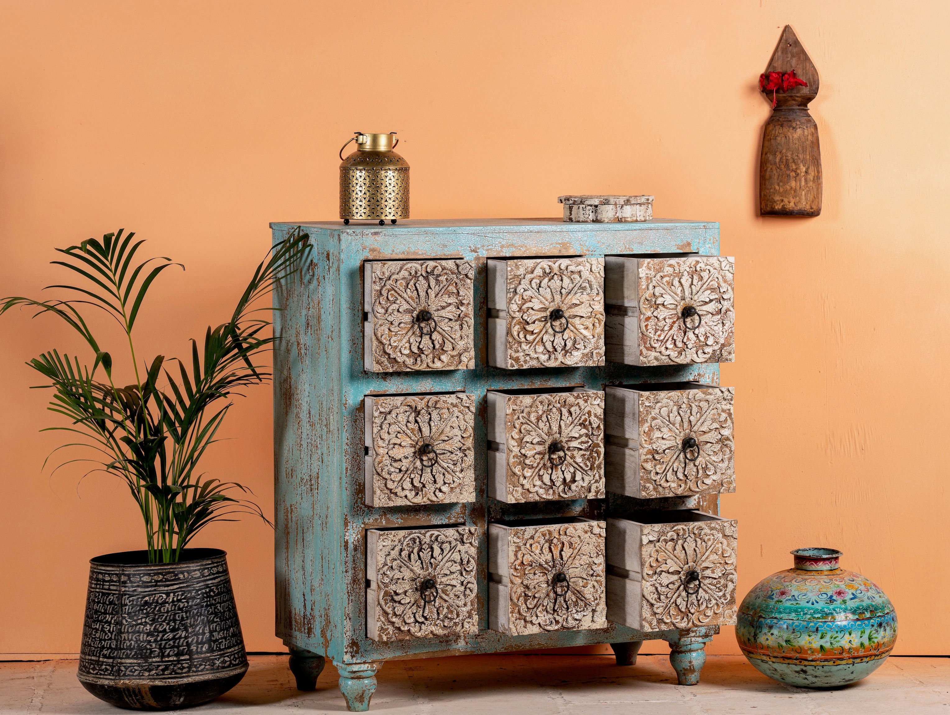Open drawer image of a hand-carved mango wood vintage chest of drawers with blue body and whitewashed floral fronts; perfect as an entryway table vintage accent, 90 × 100 × 40 cm.