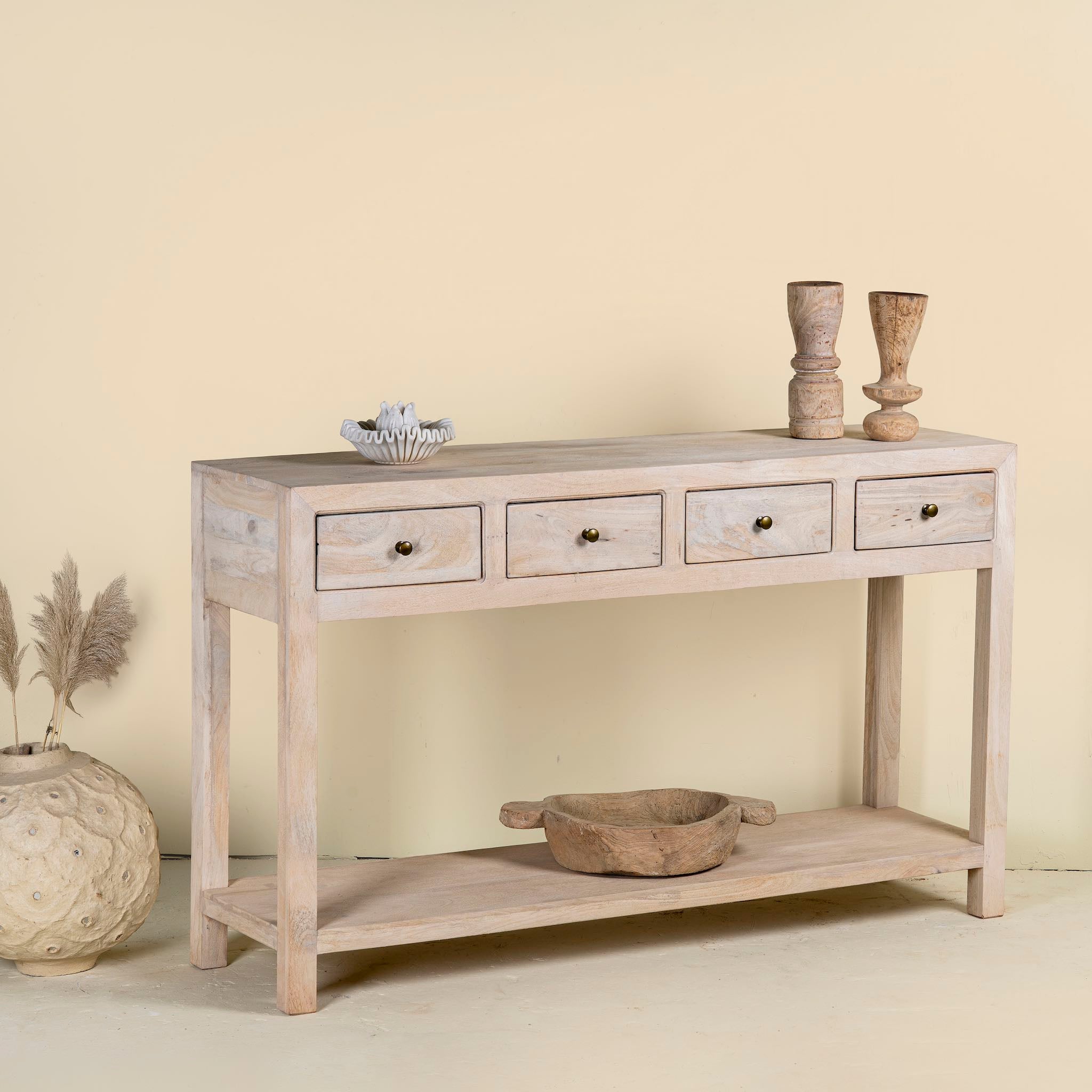 Side angle image of a sustainable reclaimed wood console table with four drawers, lower shelf, and sandblasted mango wood finish, 150 × 40 × 90 cm.