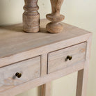 Close up image of a sustainable reclaimed wood console table with four drawers, lower shelf, and sandblasted mango wood finish, 150 × 40 × 90 cm.