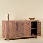 Open door image of a acacia wood cabinet with hand-carved geometric patterns, artisan carved wood furniture for living room storage, 180 × 40 × 90 cm.