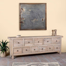 Side angle image of a reclaimed wood furniture chest of drawers with 11 drawers, Ibiza style living room furniture with sandblasted finish, 250 × 40 × 85 cm.