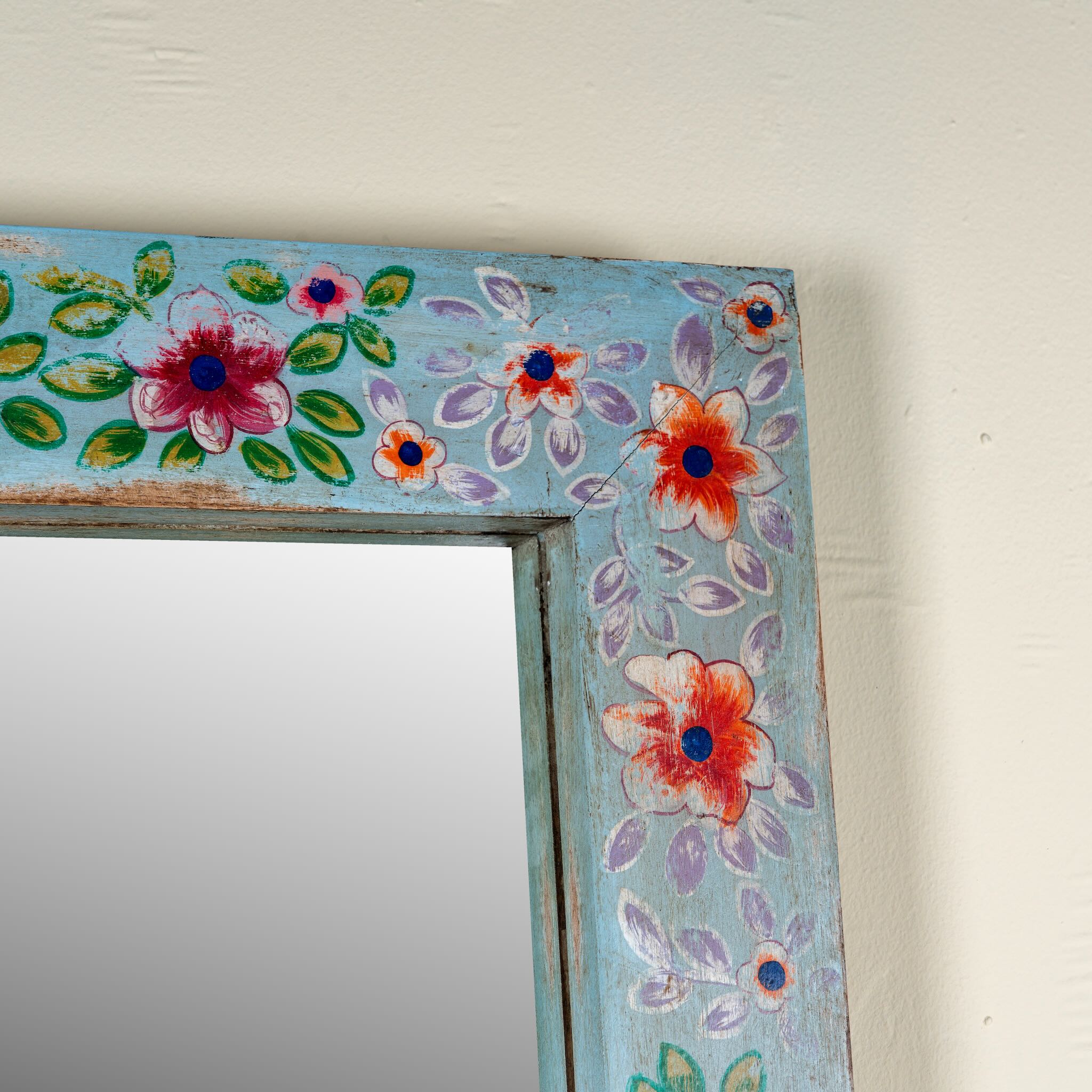 Close up image of a Aakar hand painted reclaimed wood vintage wall mirror with colourful floral frame, 180x90cm