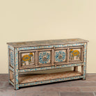 Side angle image of a Aakash hand painted reclaimed wood console table with blue floral and elephant motifs, storage and open shelf 114cm