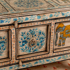 Close up image of a Aakash hand painted reclaimed wood console table with blue floral and elephant motifs, storage and open shelf 114cm