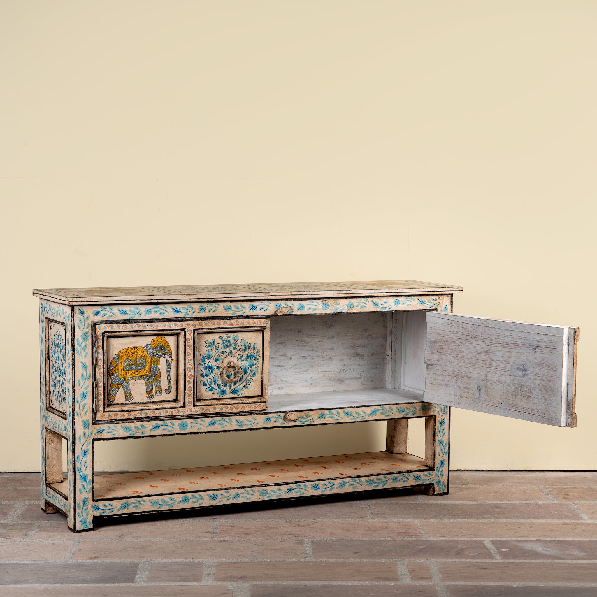 Image showing open door of a Aakash hand painted reclaimed wood console table with blue floral and elephant motifs, storage and open shelf 114cm