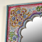 Close up image of a uniquely hand painted Indian window arch mirror made of reclaimed wood in Boho style..