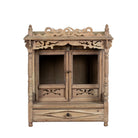 White background image of an antique reclaimed Indian teak wood house temple with hand carvings, two doors and one drawer.