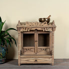 Image of an antique reclaimed Indian teak wood house temple with hand carvings, two doors and one drawer.