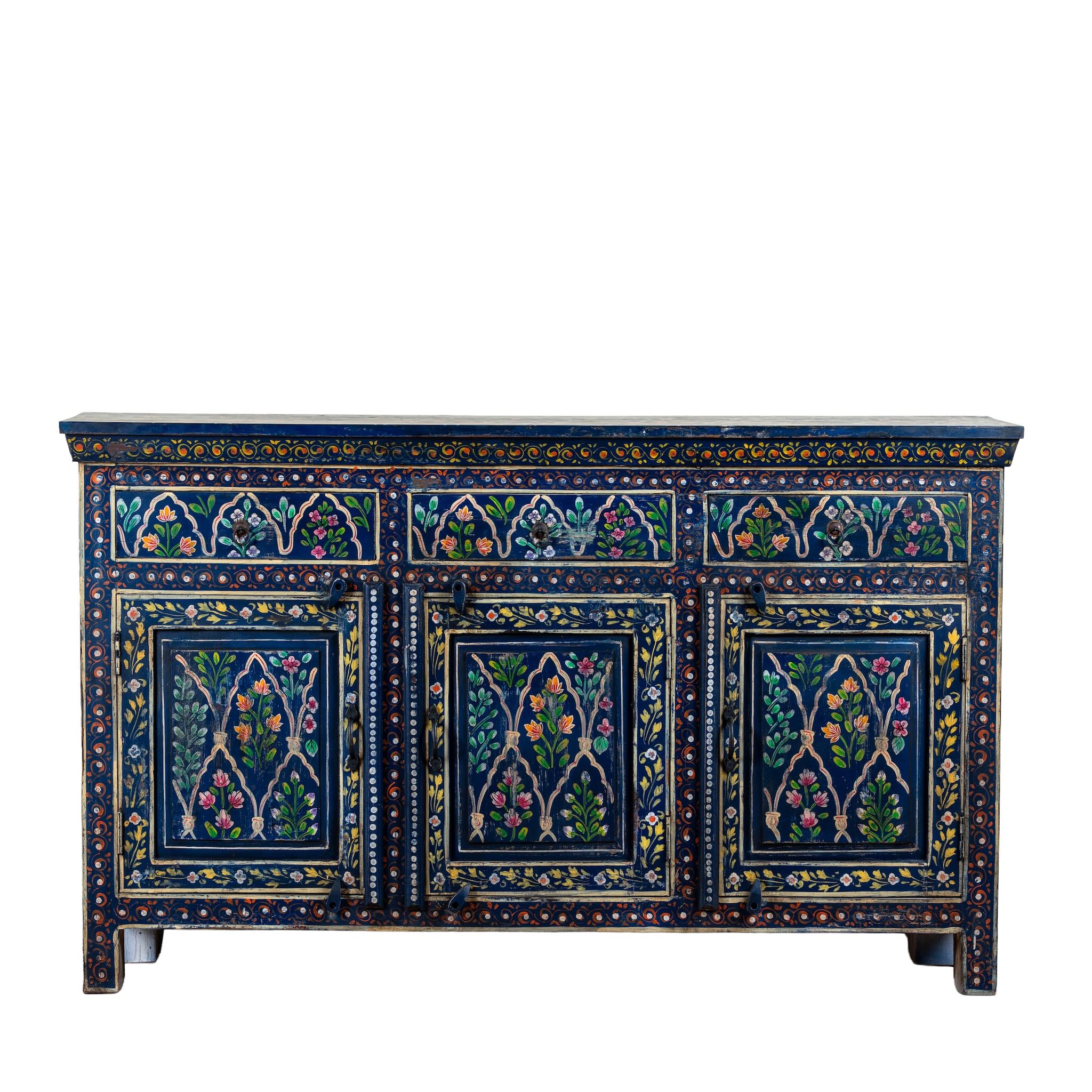 White background image of an Indian hand painted sideboard made of reclaimed wood in vintage style with 3 drawers and doors and ample storage.