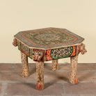 Side angle image of a Aaroh hand-painted reclaimed wood coffee table with sculpted tiger heads and colourful ornamental design 80cm