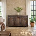 Lifestyle image of a dark brown hand carved mango wood sideboard with floral design and ample storage.