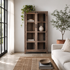 Lifestyle image of a driftwood display cabinet with 2 glass doors and 4 shelfs in rustic design.