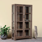 Side angle image of a driftwood display cabinet with 2 glass doors and 4 shelfs in rustic design.
