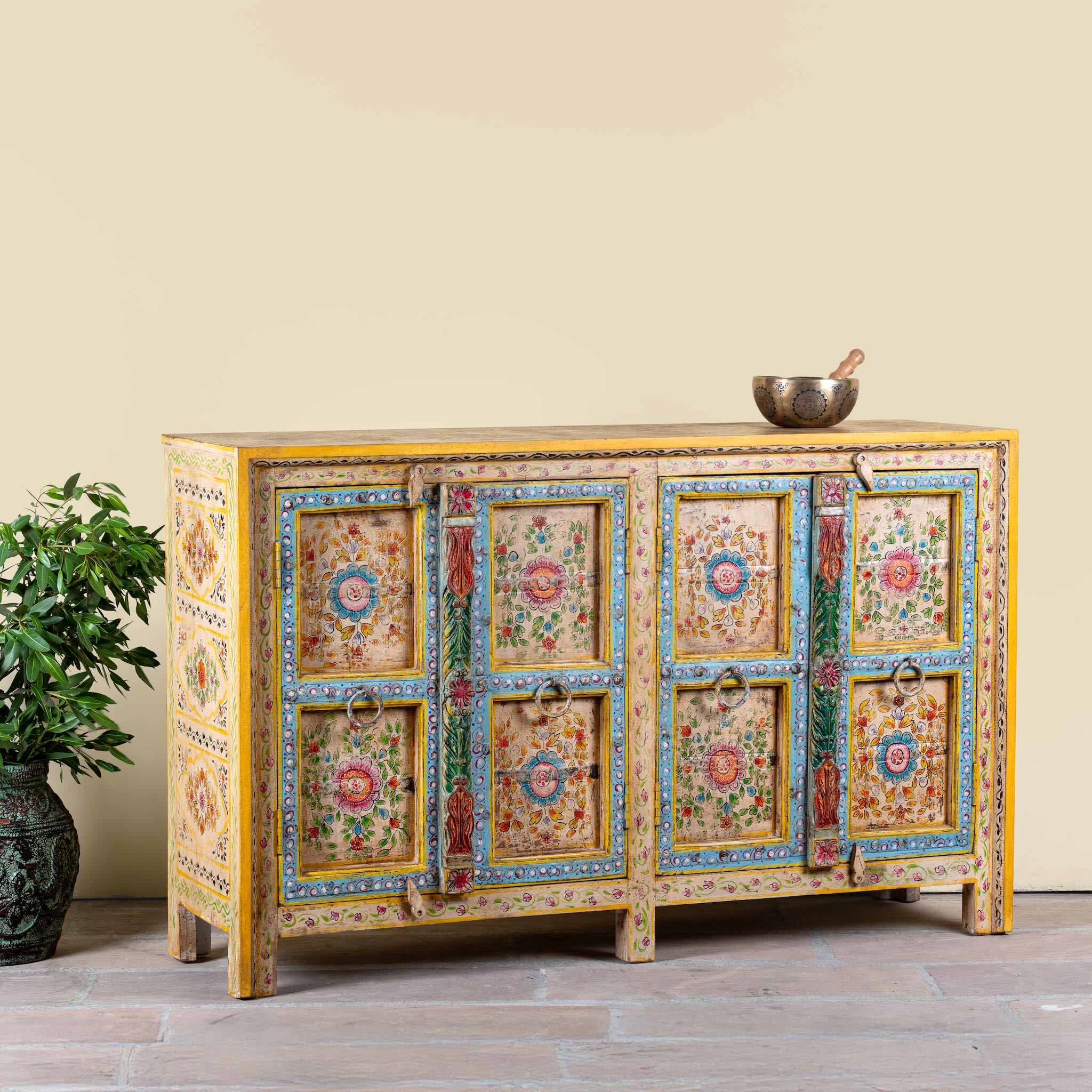 Side angle image of a Aashish-hand-painted-sideboard-reclaimed-wood-150cm with floral design.