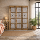 Lifestyle image of a hand carved wardrobe with floral design made of mango wood in vintage style.