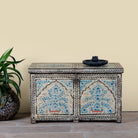 Image of a decorative wooden box coffee table with intricate hand painted patterns made of reclaimed wood in a living room setting