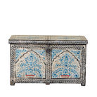 White background image of a decorative wooden box coffee table with intricate hand painted patterns made of reclaimed wood in a living room setting