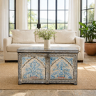 Life style image of a decorative wooden box coffee table with intricate hand painted patterns made of reclaimed wood in a living room setting