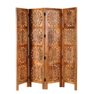 White background image of a foldable room partition made of mango wood, featuring four panels with symmetrical hand-carved circular floral medallions, finished in a rich natural wood tone and connected by black metal hinges for easy folding and adjustment.
