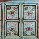Close up image of a large hand painted, 2 parts, Mango wood display cabinet wit 8 doors and ample inside storage in vintage design.
