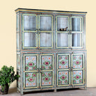 Side angle image of a large hand painted, 2 parts, Mango wood display cabinet wit 8 doors and ample inside storage in vintage design.