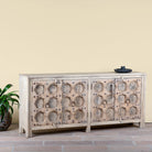 Side angle image of an Indian antique door sideboard with ample storage and original iron settings.