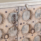Close up image of an Indian antique door sideboard with ample storage and original iron settings.
