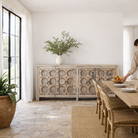 Lifestyle image of an Indian antique door sideboard with ample storage and original iron settings.