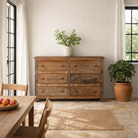 Lifestyle image of a chest of 6 drawers in Japandi style made of reclaimed dark wood.
