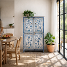 Lifestyle image of a unique hand painted wardrobe made of reclaimed wood with floral design, 4 doors and ample storage.