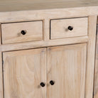 Close up image of a sandblasted wooden sideboard with three compartments and two small drawers, Ibiza style living room furniture in light natural finish, 200×40×90 cm.